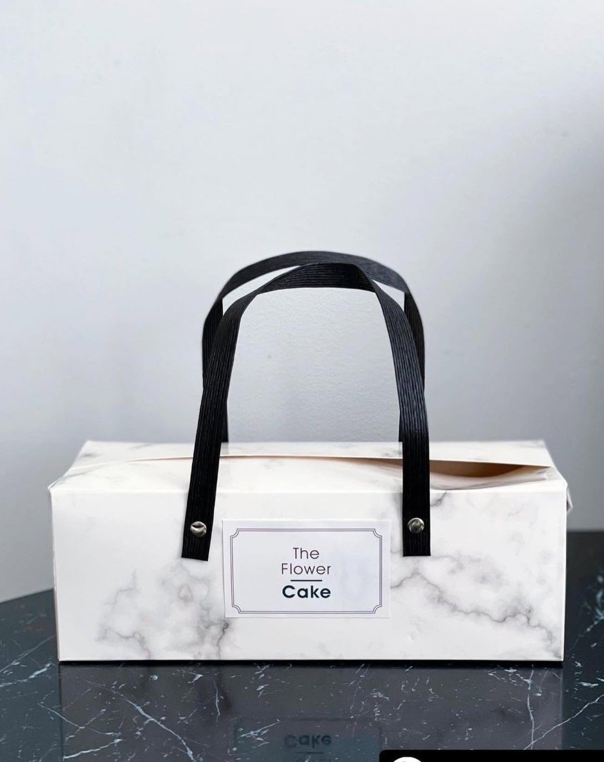 A marble gift box with The Flower Cake label
