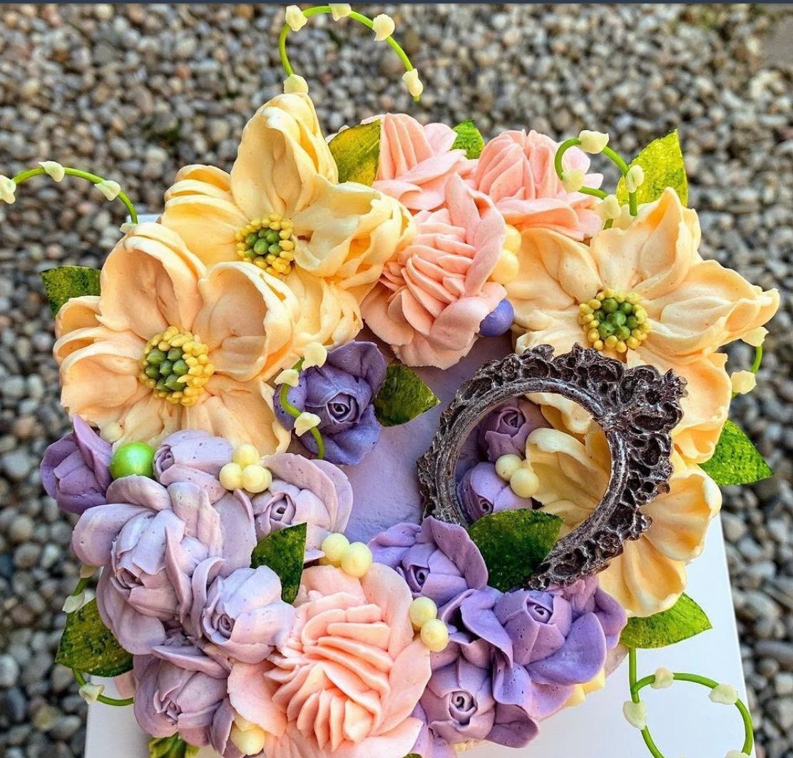 Peach and purple buttercream flower cake with an oval frame