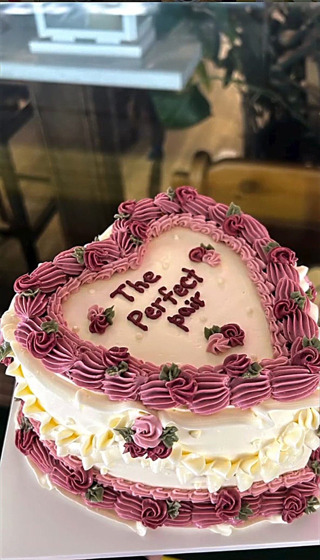 Heart cake with burgundy piping and the words The Perfect Pair