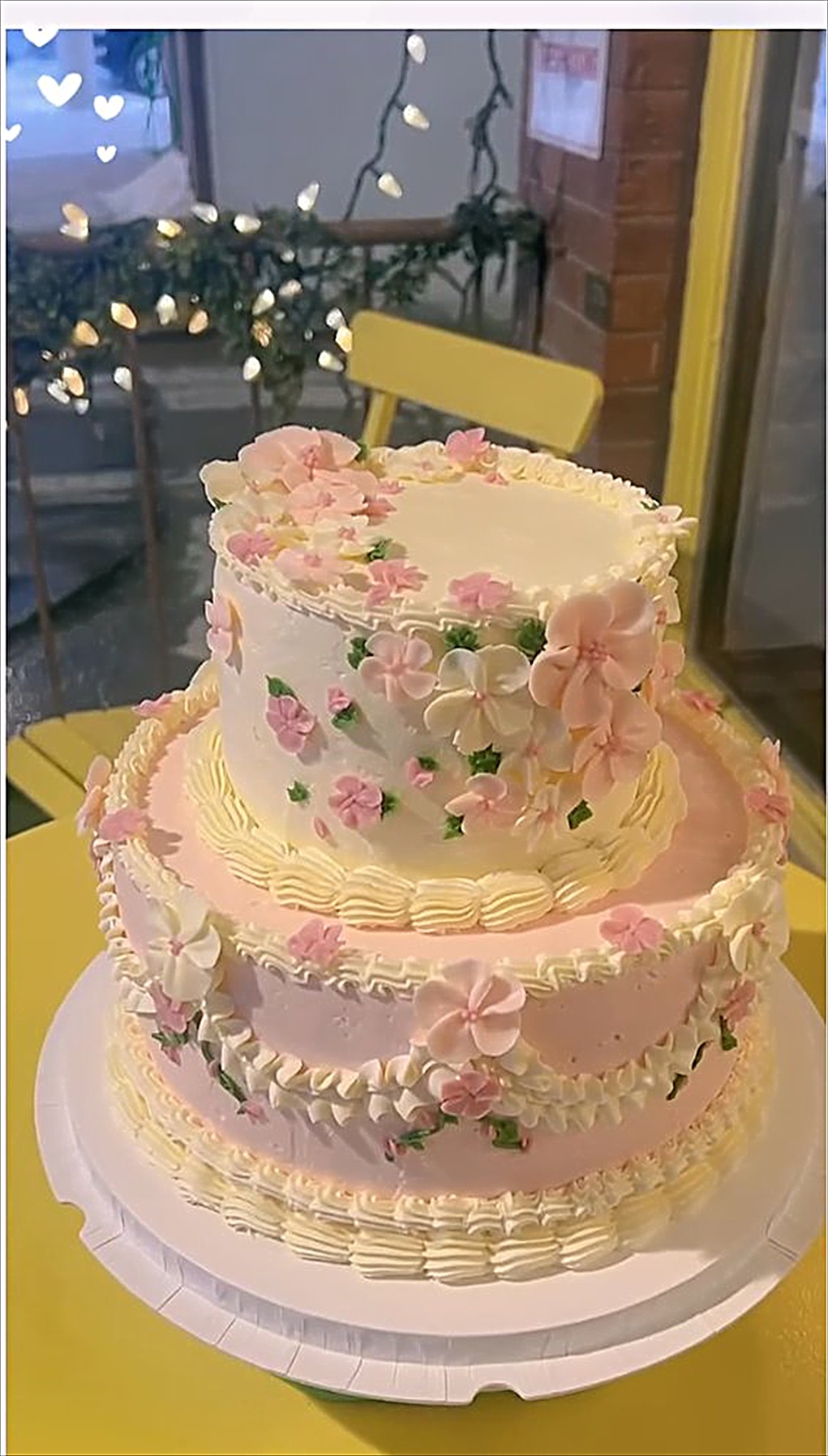 A two tier pink vintage cake for sixty guests
