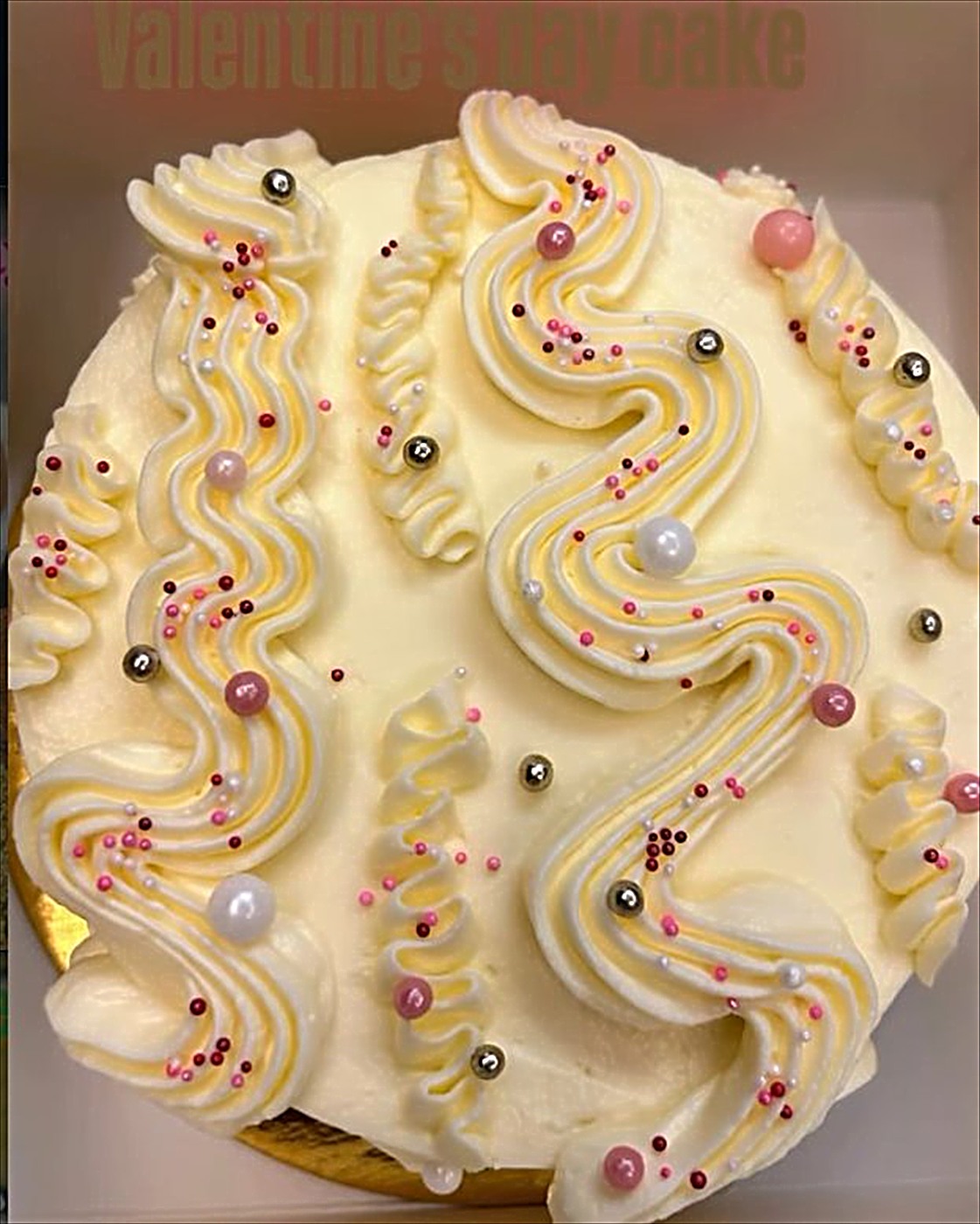 White vintage cake with swirls and pearls