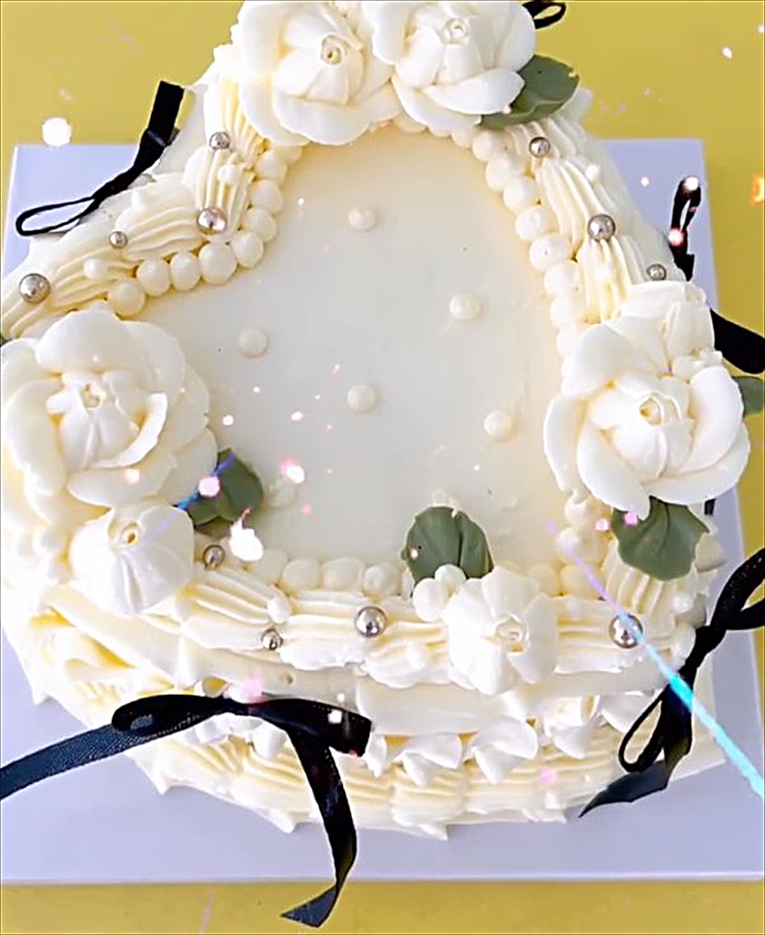 White vintage heart cake with pearls and black ribbon